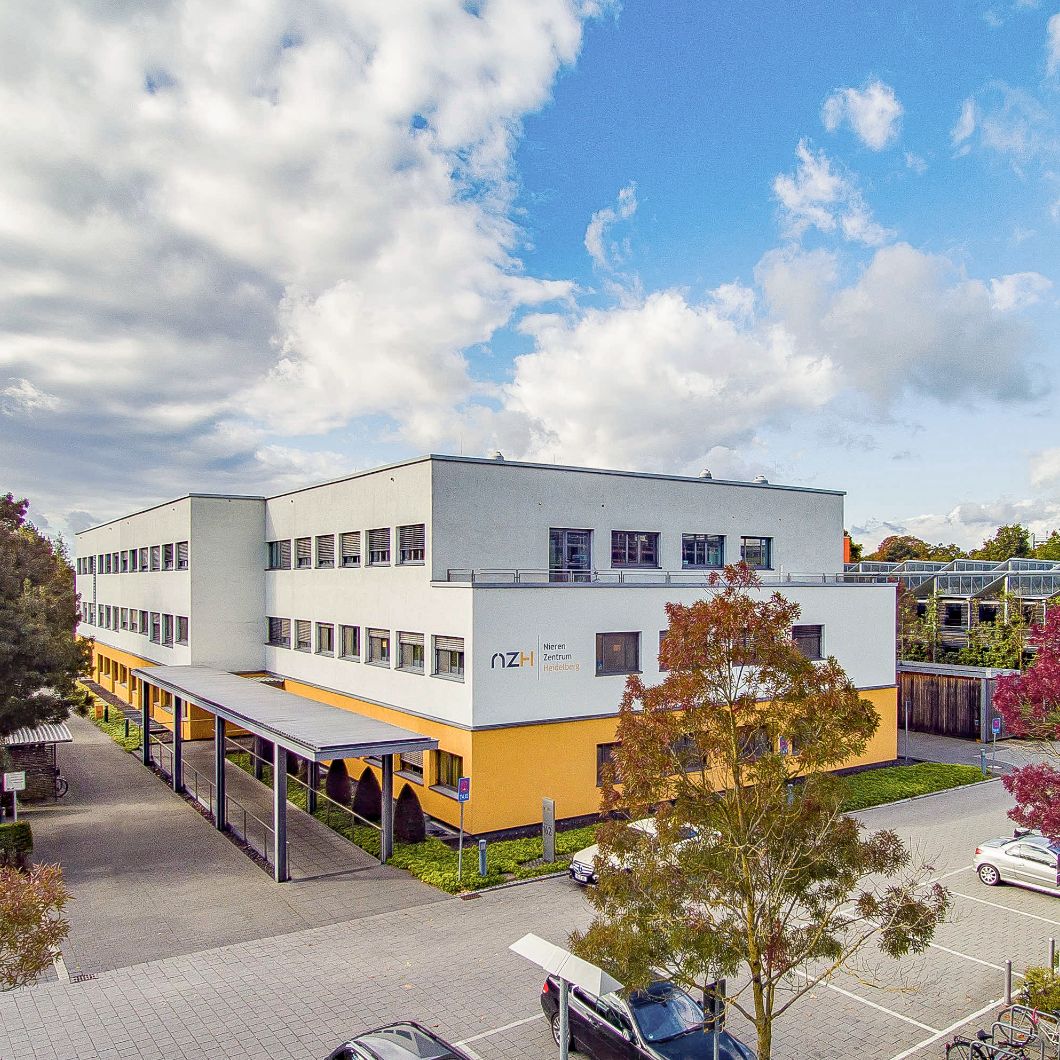 Three-storey kidney centre with yellow ground floor and covered entrance area.