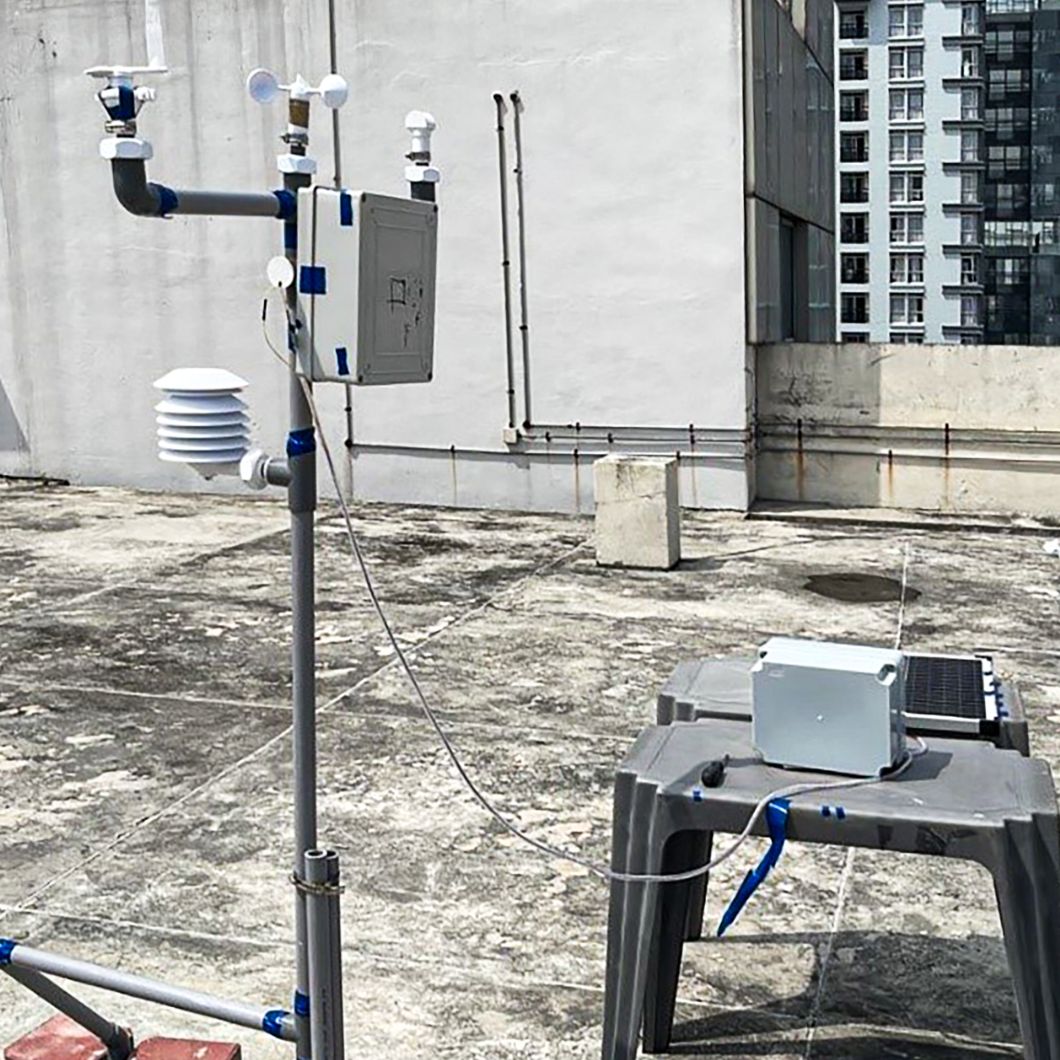 A simple weather station on a grey concrete roof in Malaysia: rain collectors and solar cells provide important environmental data for a research project.